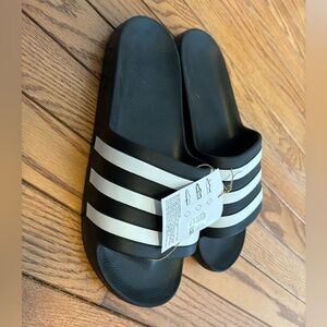 Adidas slides. 

Unisex Women’s 10/Mens 9